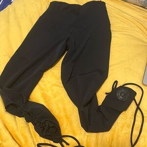 Pure Barre x Onzie black legging with open cross ties on calves